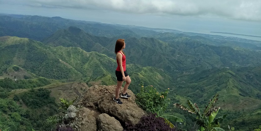 Women reaching the peak of a mountain